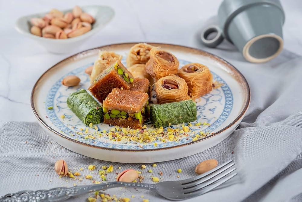 A beautifully presented table setting with a plate of hazelnut baklava and a glass of wine