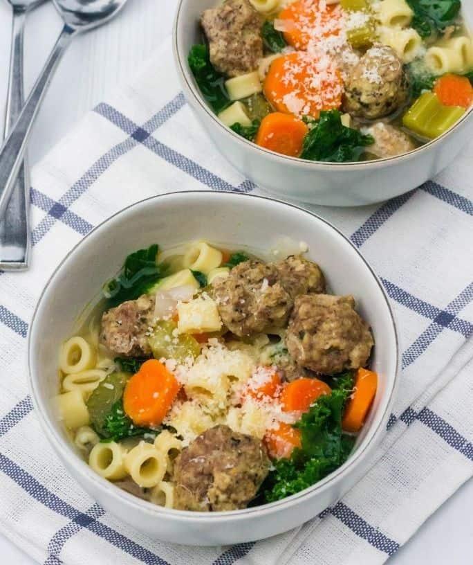 A family gathered around a table enjoying bowls of Instant Pot Italian Wedding Stew