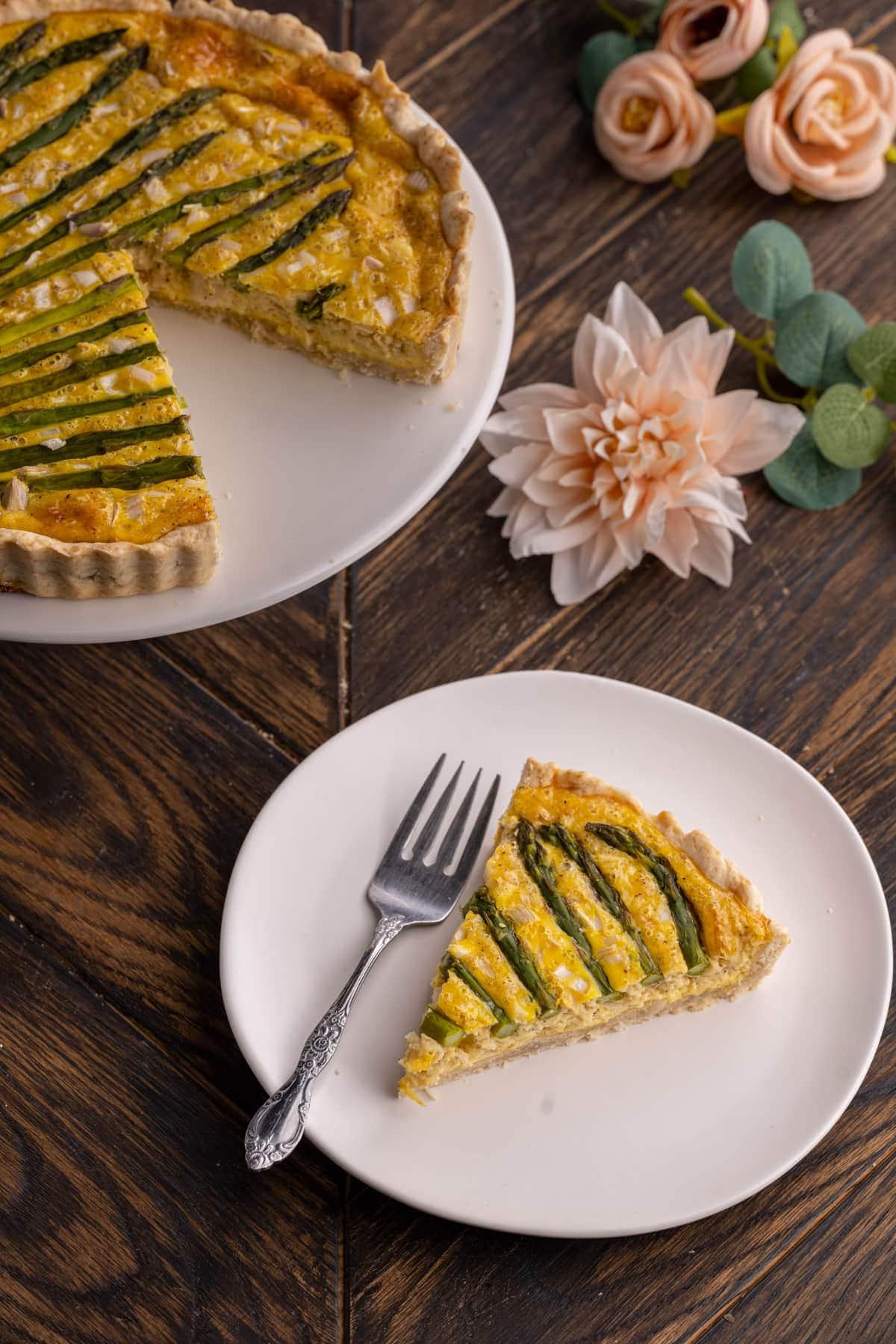 Close-up shot of a slice of Asparagus and Smoked Gouda Quiche, showcasing the layers and textures