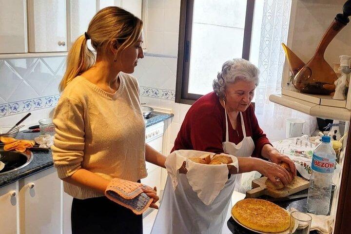 Grandma smiling while cooking paella