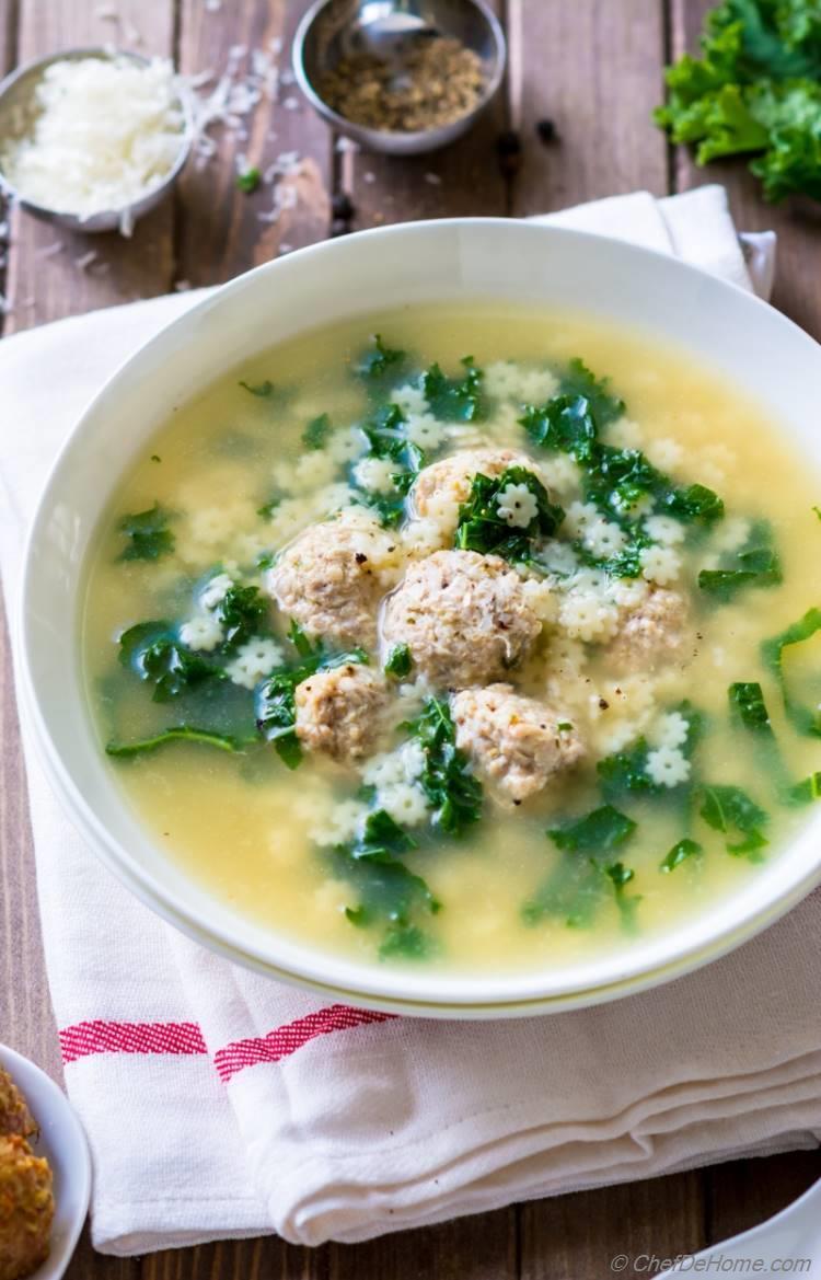 bowl of one-pot italian wedding soup garnished with parsley and parmesan cheese