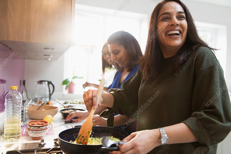 Woman happily baking in kitchen