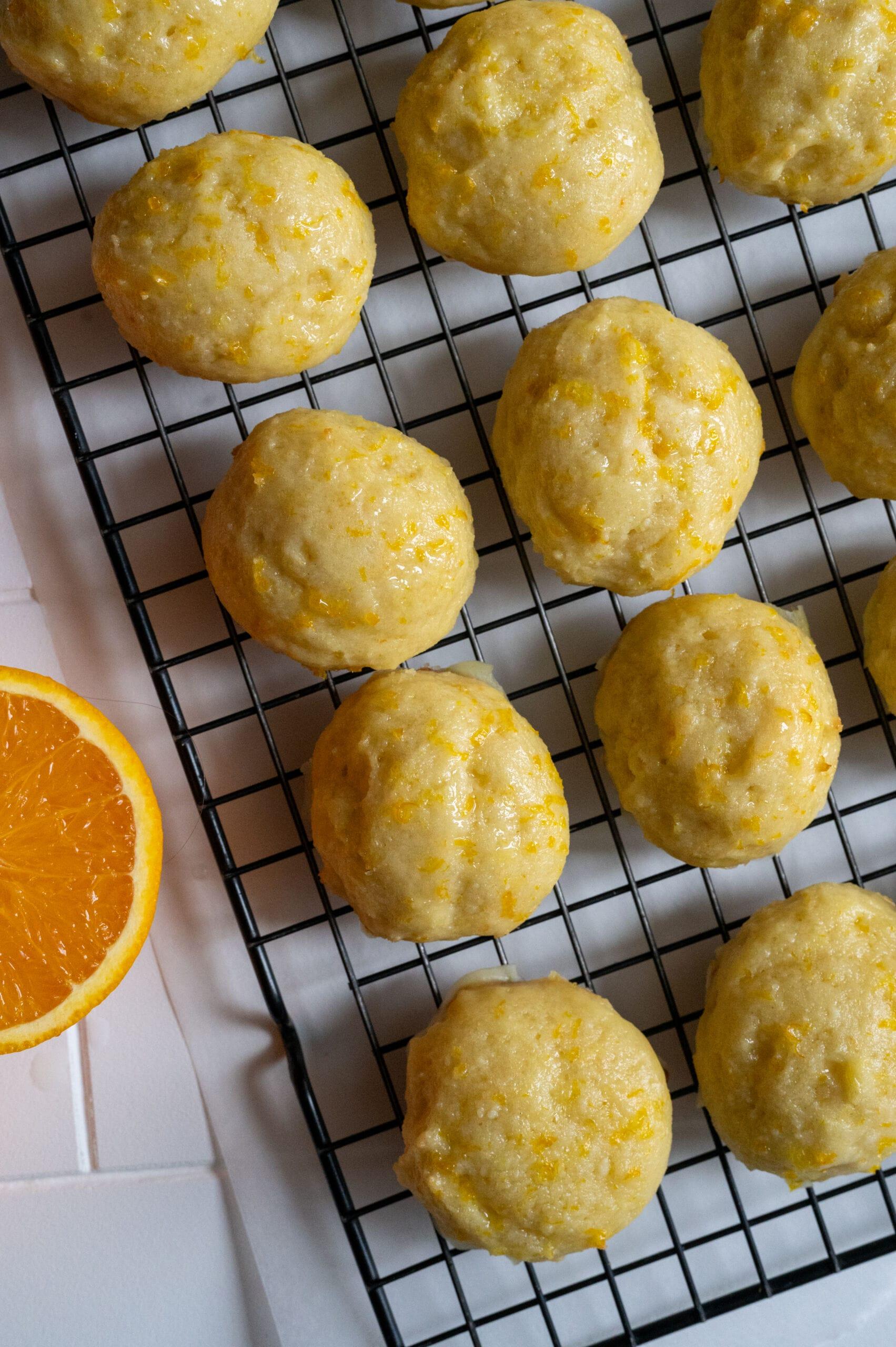 Freshly baked orange zest cookies cooling on a wire rack, steam gently rising