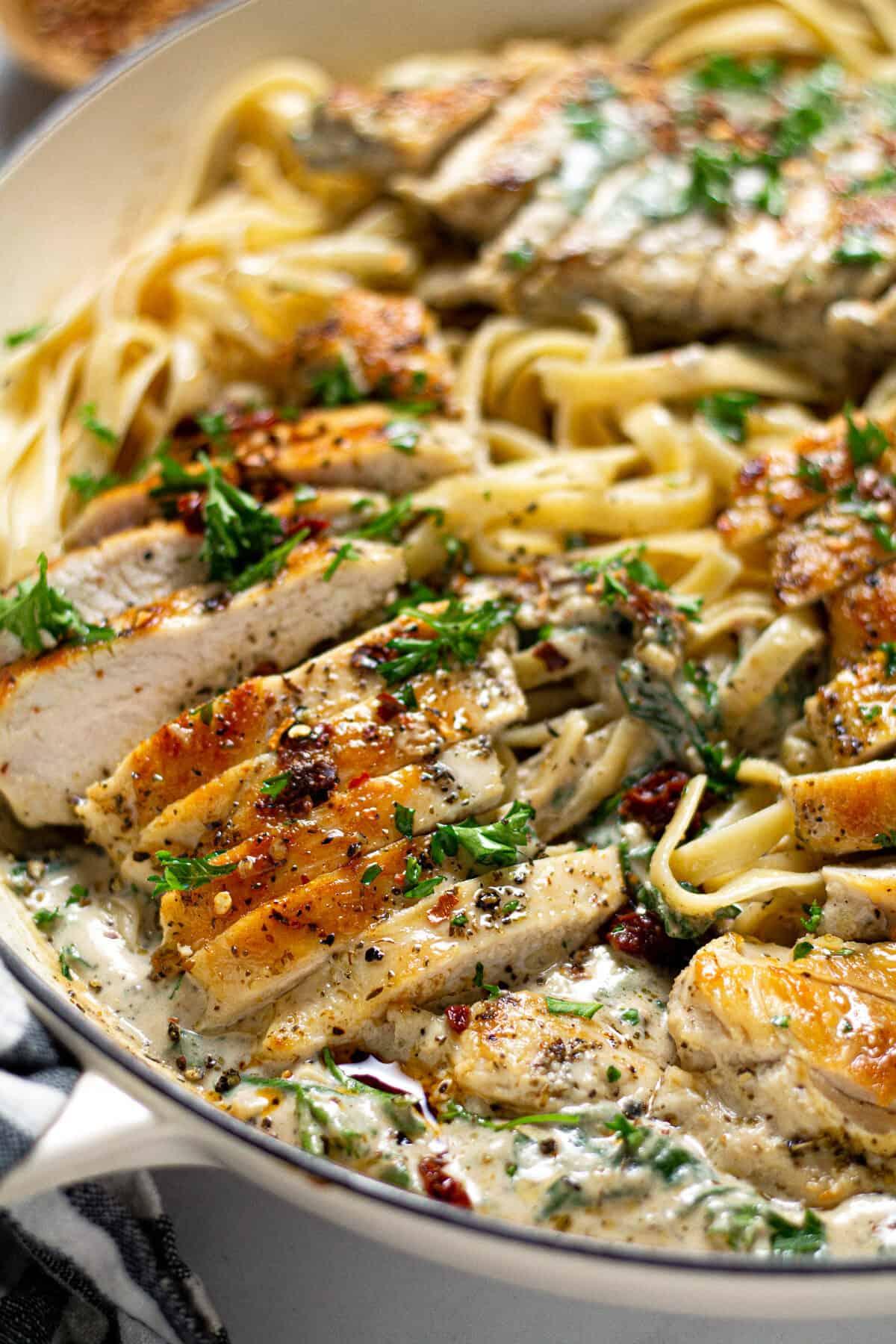 Close up shot of creamy tuscan chicken with pasta