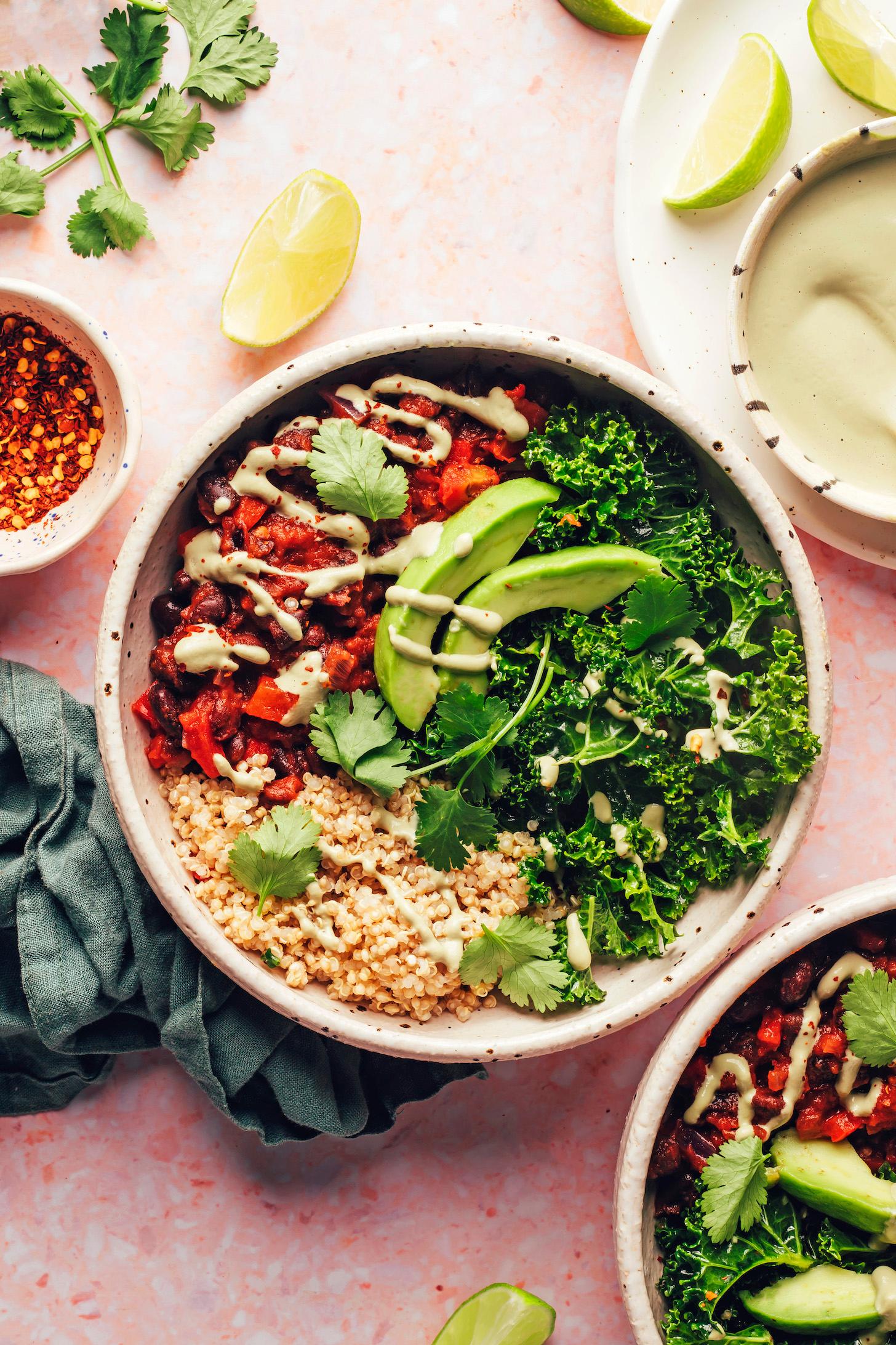 overhead shot of several bowls of quinoa chili with various toppings