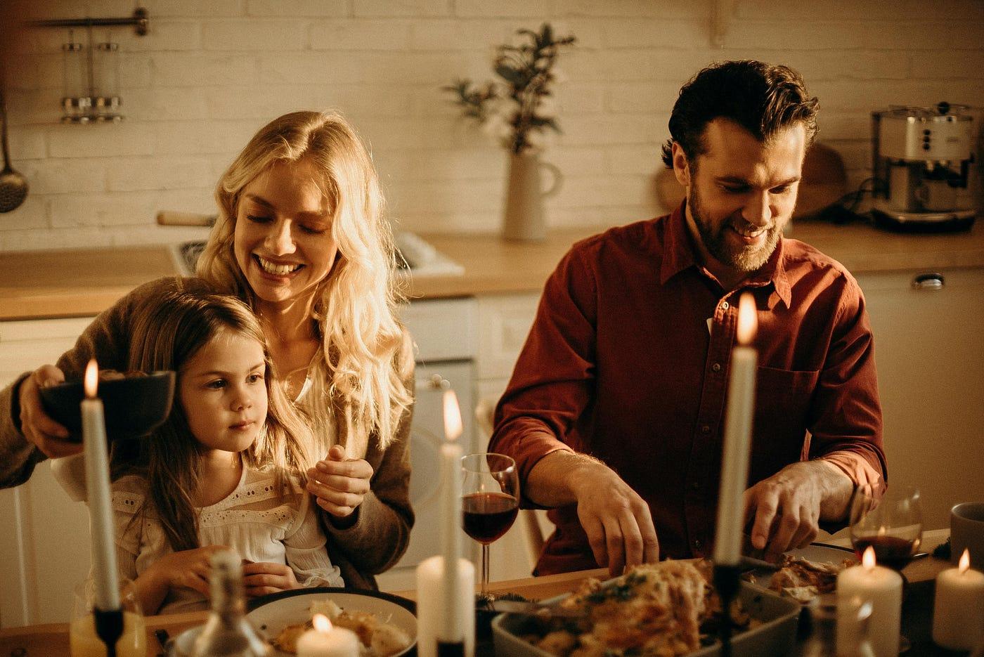 Smiling family enjoying a slow-cooked meal together at dinner table, cozy kitchen atmosphere
