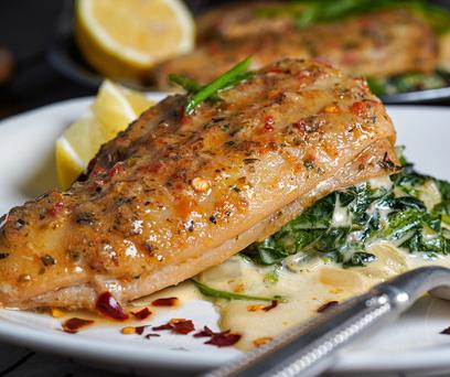 the finished steamed flounder with spinach and parmesan plated and garnished