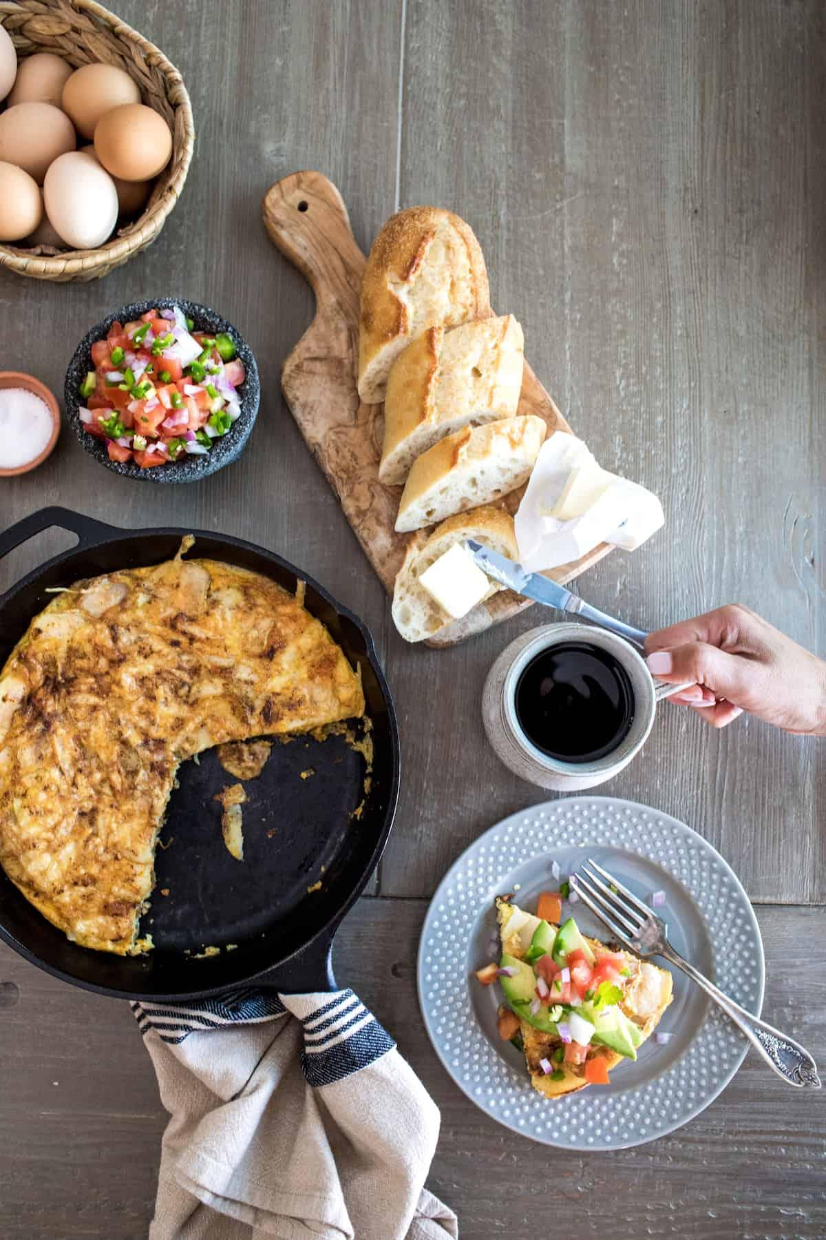 Ingredients for a frittata laid out on a wooden table.
