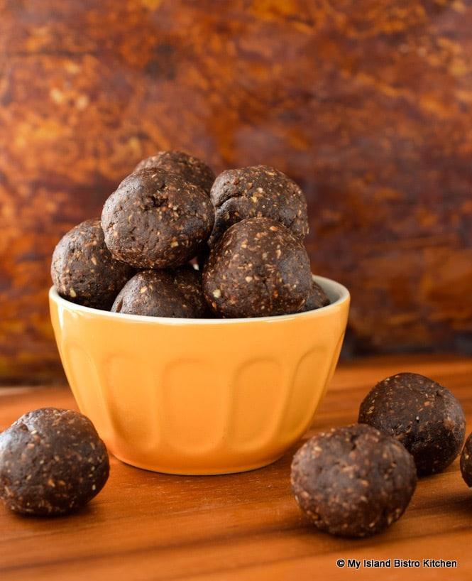 close up shot of coffee date energy bites on a rustic wooden surface