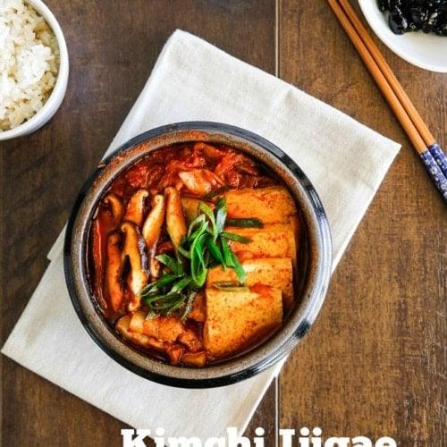 Close-up of kimchi jjigae being served in a traditional Korean bowl