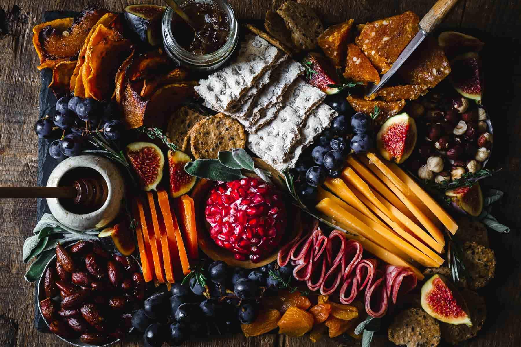 Black pepper cashew-cheese biscuits with fig jam on a wooden board