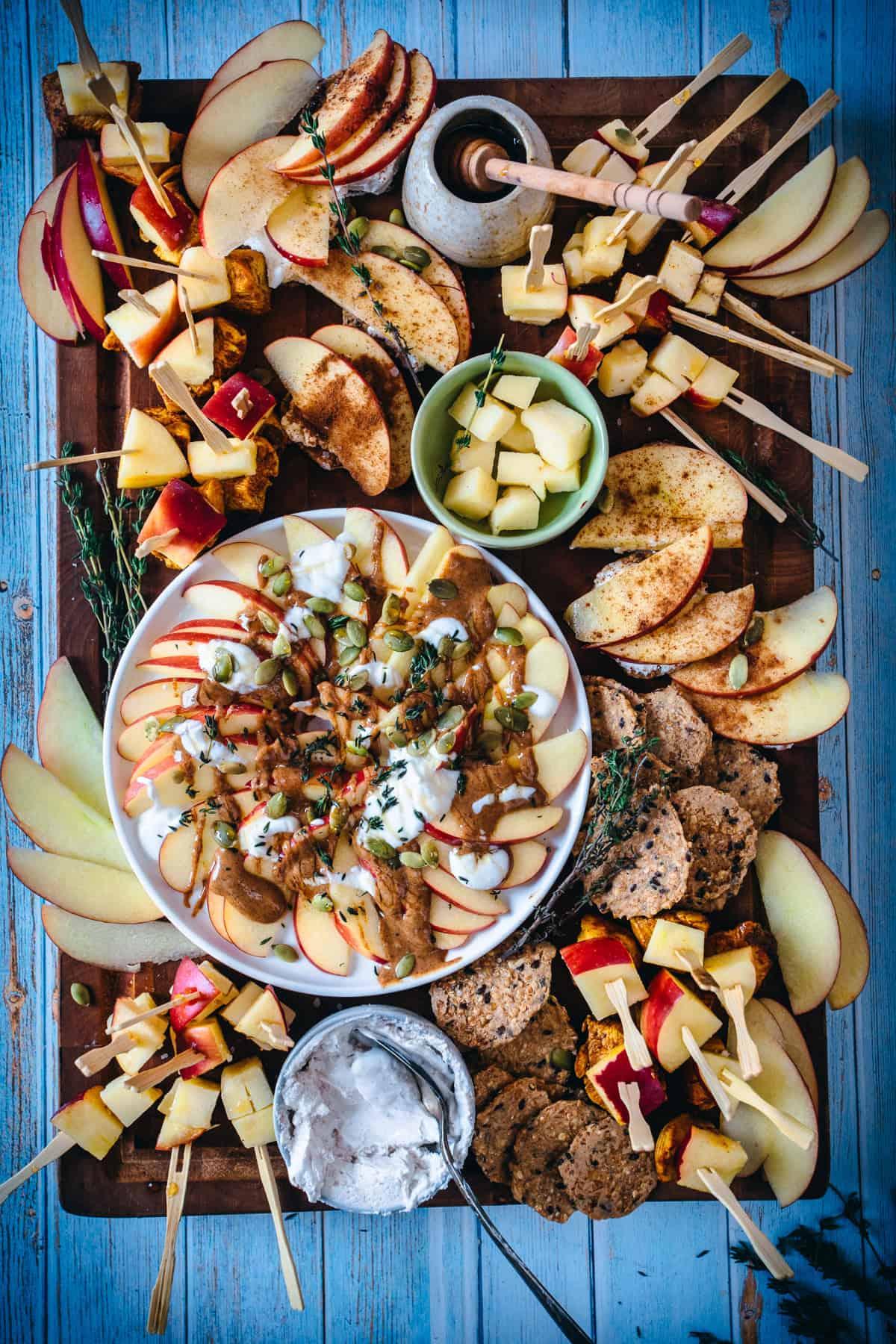 Overhead shot of colorful Dulce de Leche Apple Nachos arranged on a wooden platter