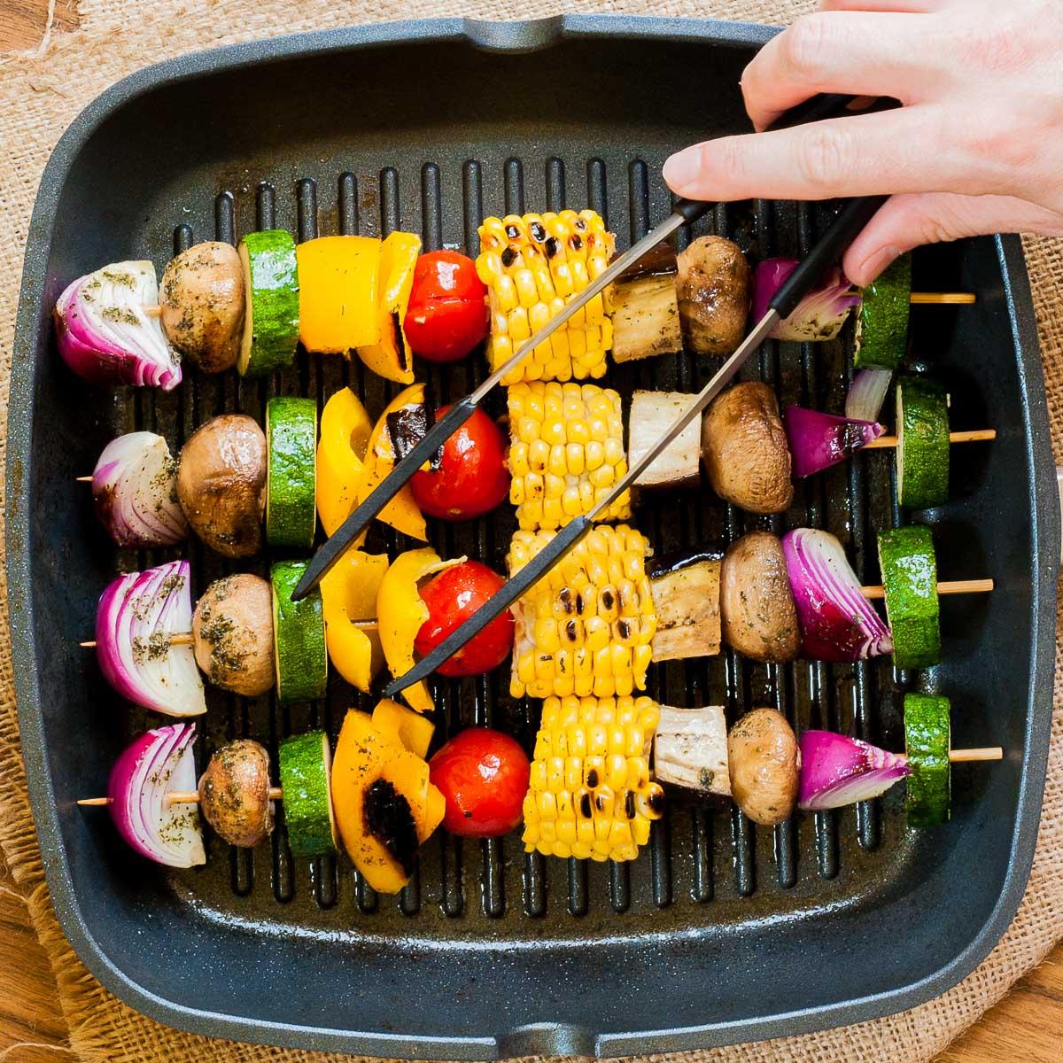 grilled corn and vegetable skewers on a grill