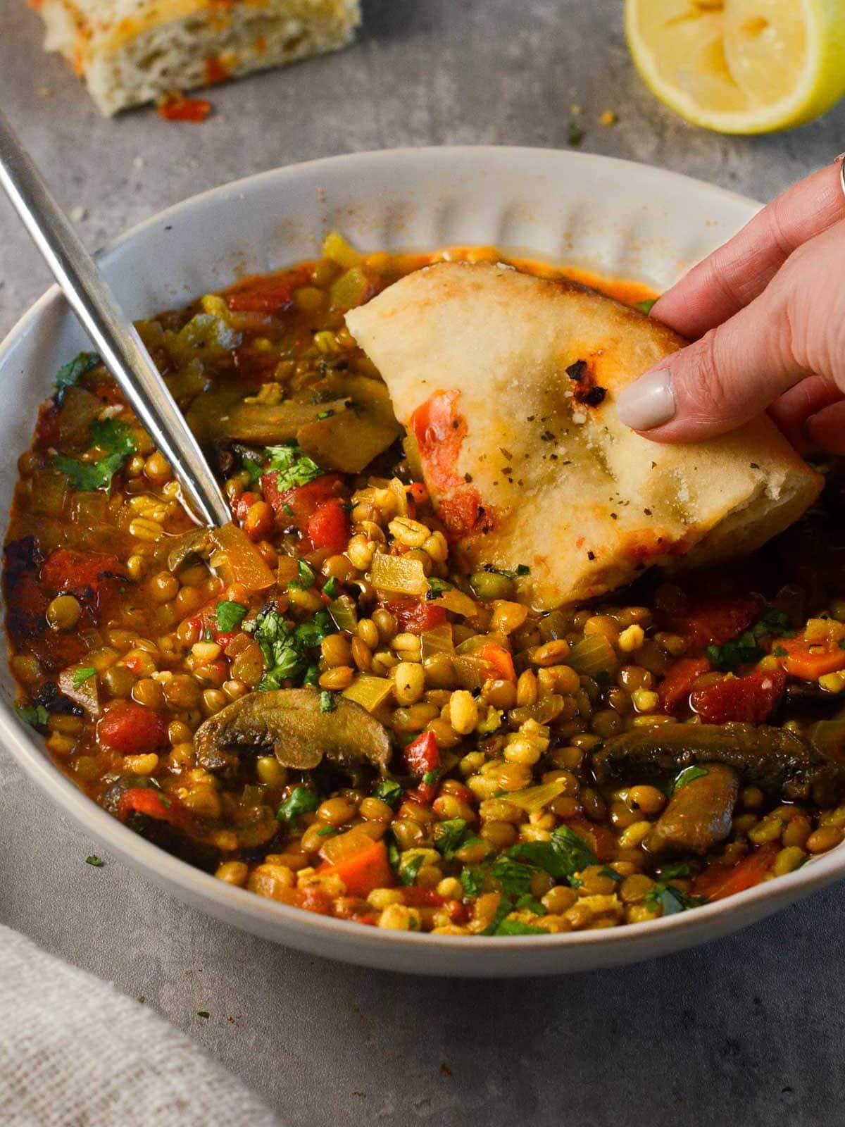 bowl of barley lentil soup with vegetables