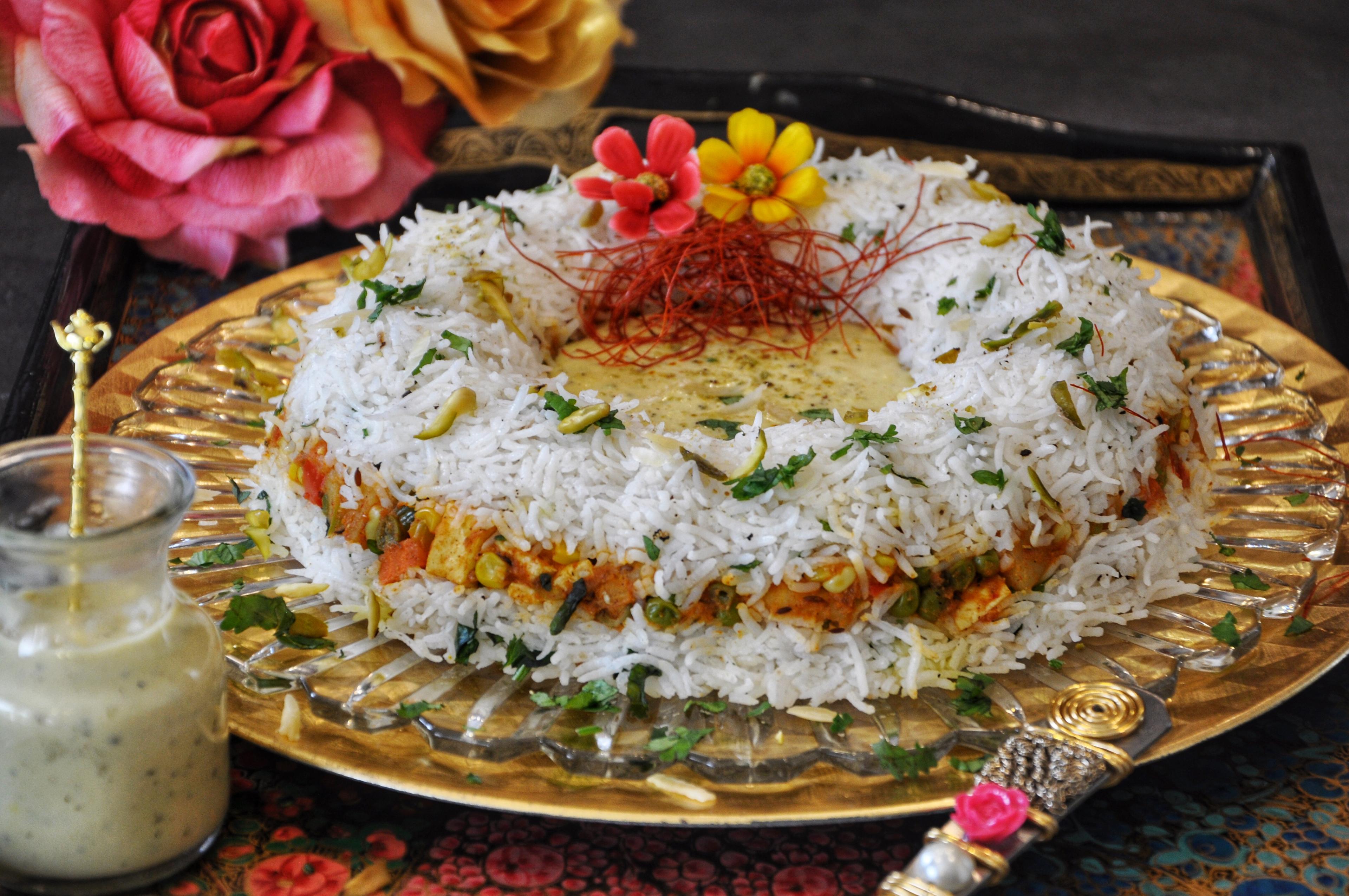 close up of almond biryani served in a traditional pot