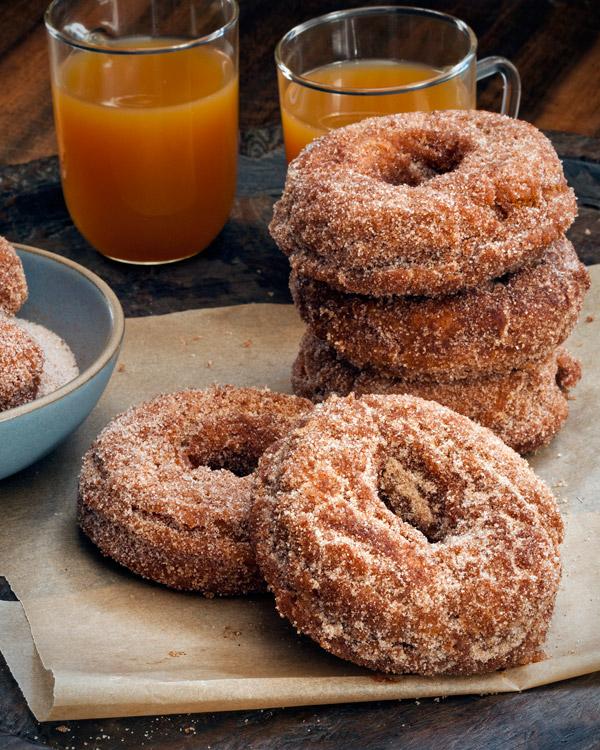 homemade spiced apple cider donuts on a wooden table