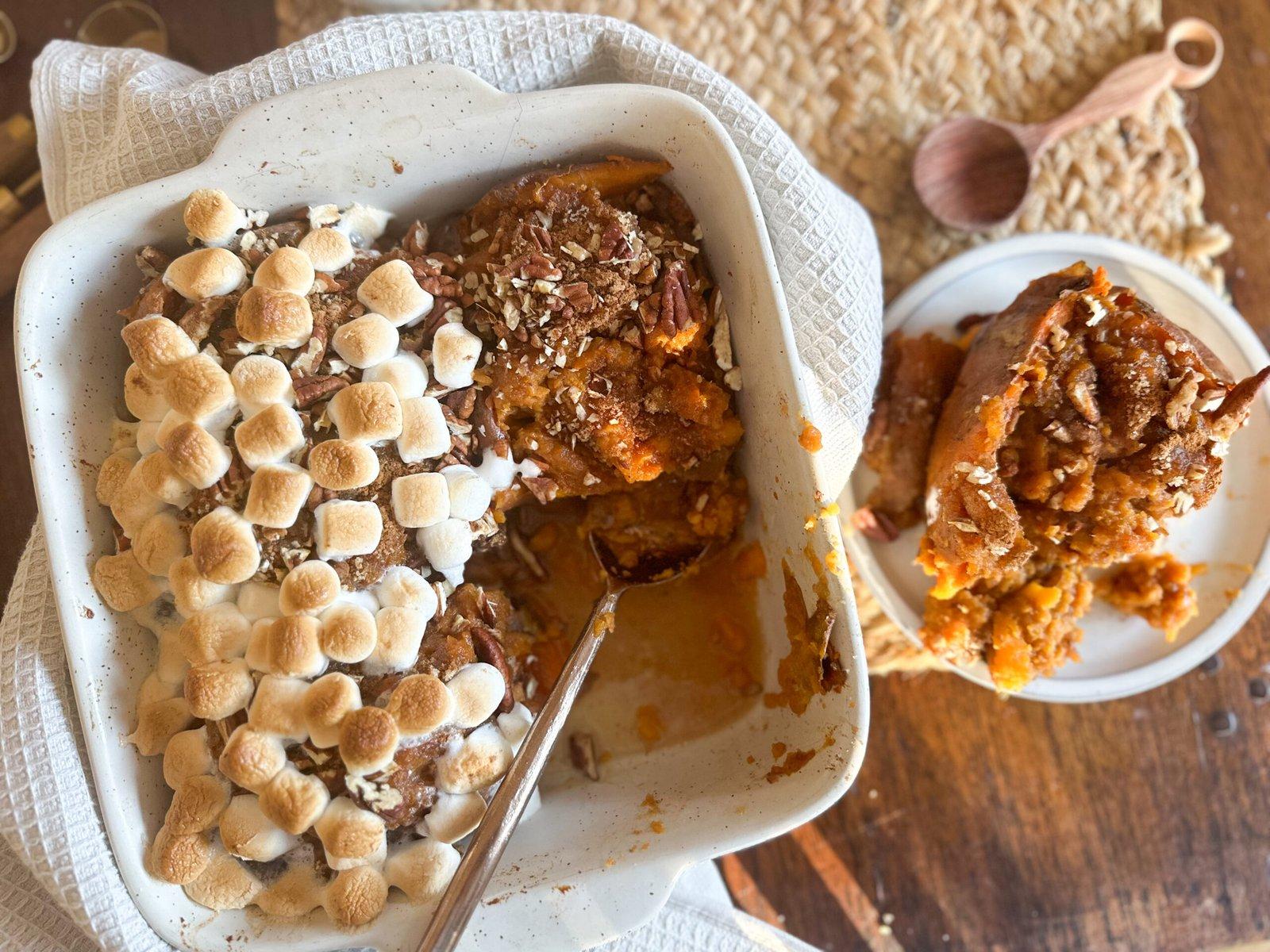 Aunt Carol's sweet potato casserole on a festive holiday table with family members laughing in the background