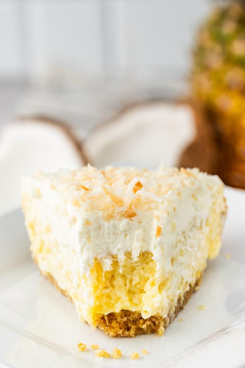 slice of pineapple coconut cream pie with toasted coconut flakes