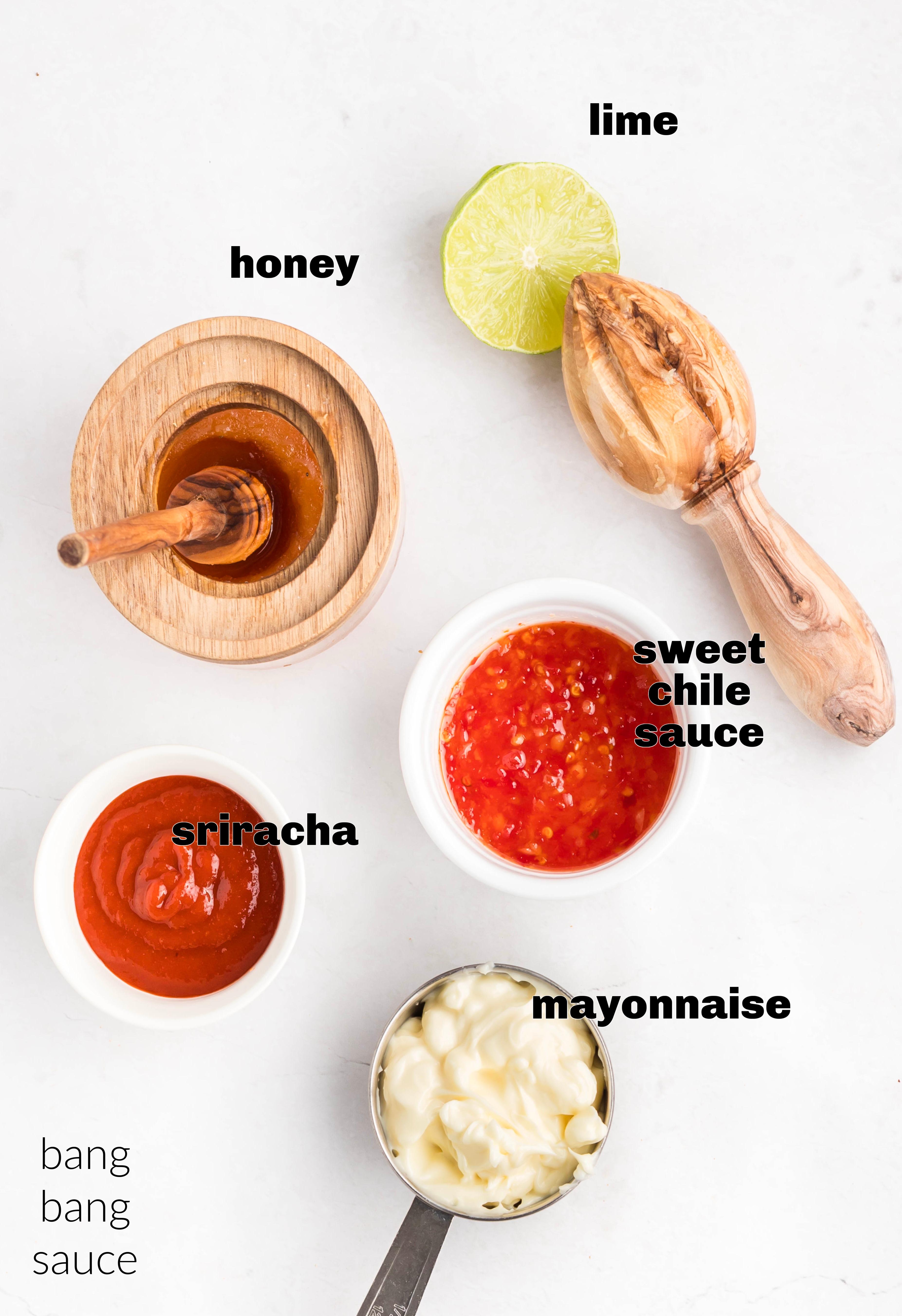 Ingredients for Bang Bang sauce laid out: mayonnaise, sweet chili sauce, sriracha, honey