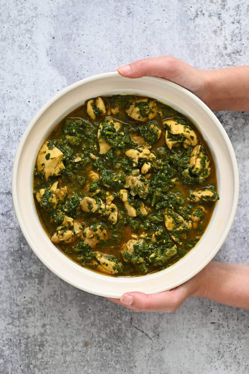 A steaming bowl of Chicken Saag, shot from above