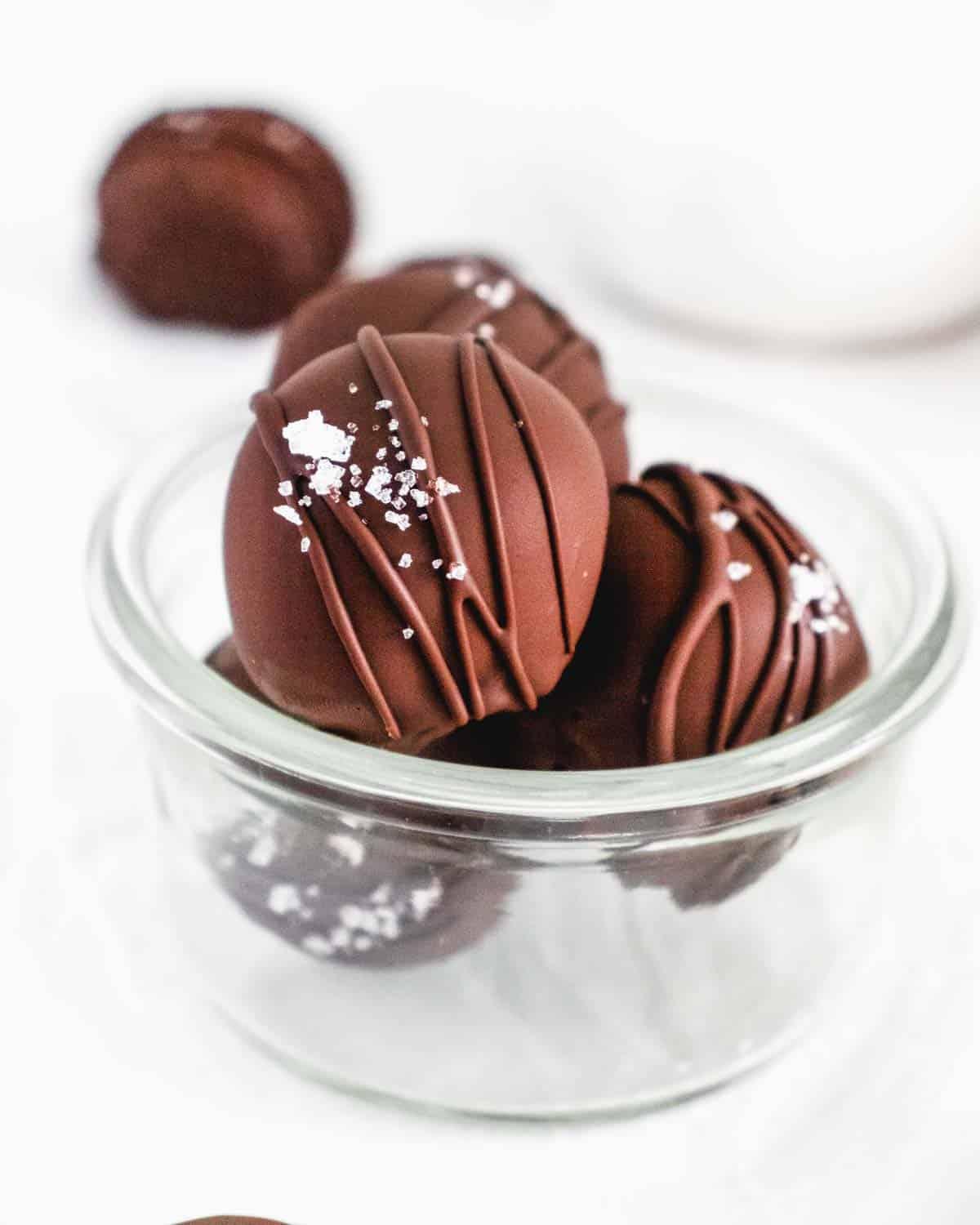 Close-up of a smooth, dark espresso truffle mixture being stirred in a glass bowl