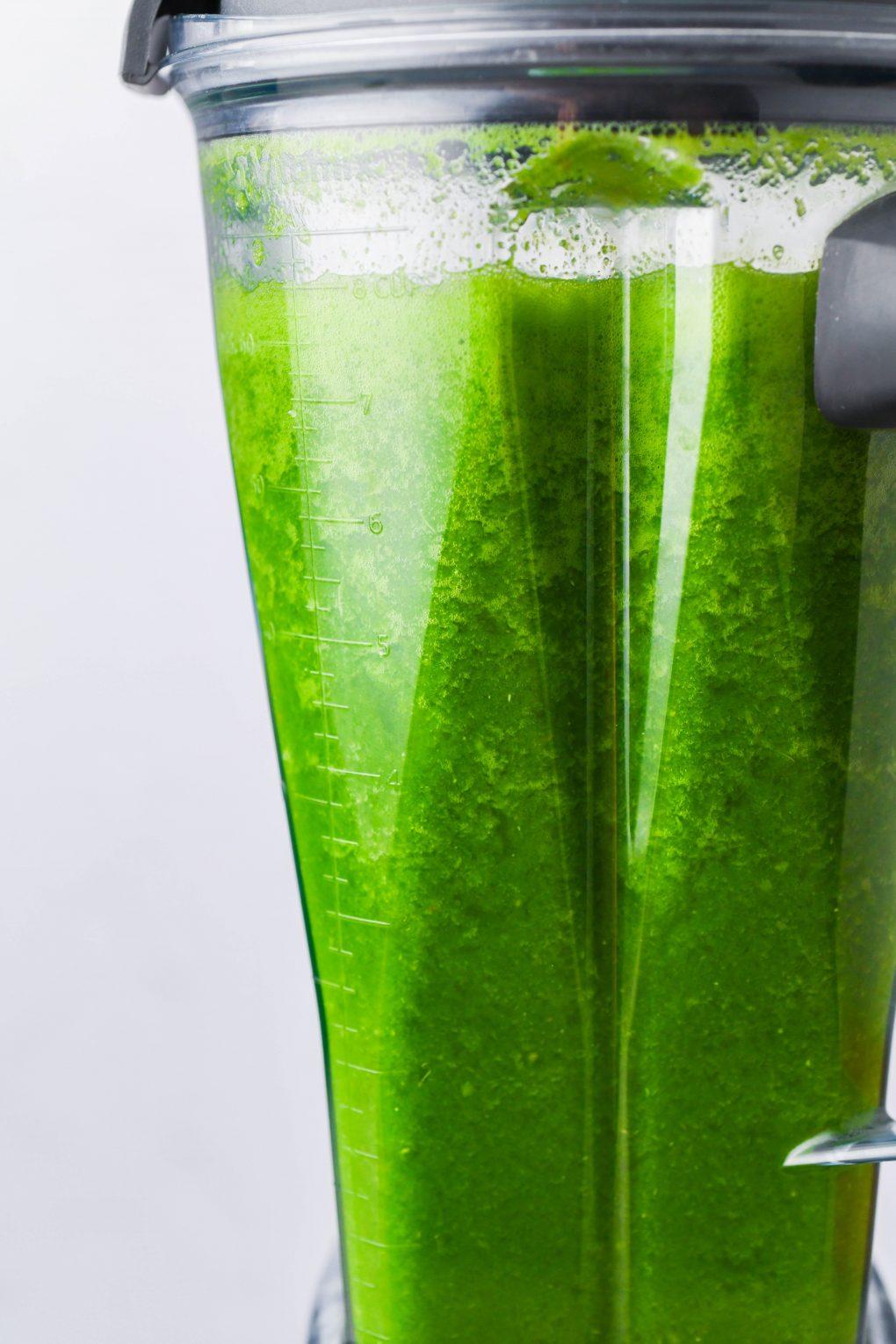 close-up shot of a freshly blended green grape smoothie being poured into a glass
