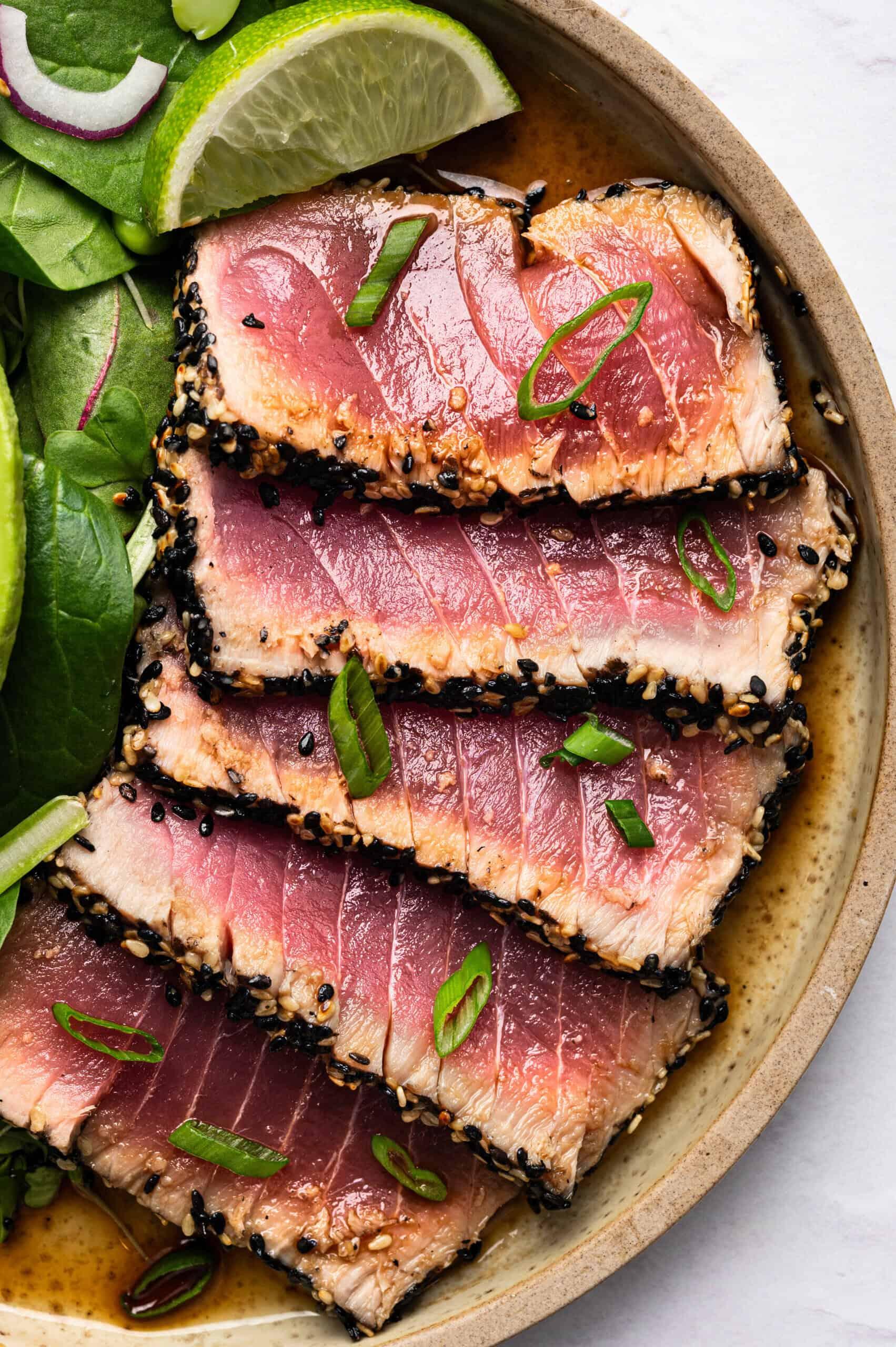 seared ahi tuna steak with ponzu sauce, sesame seeds, and green onions