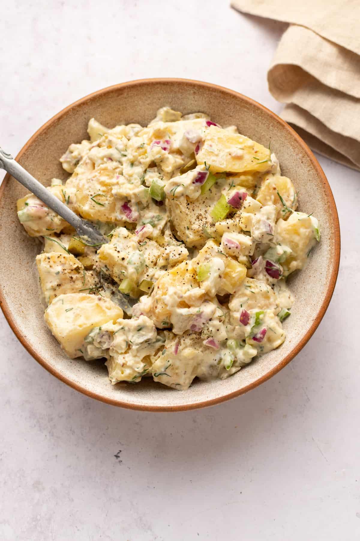 creamy dill potato salad in a rustic bowl