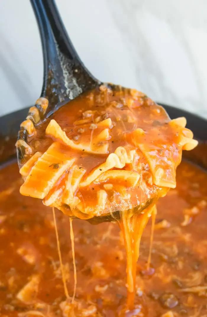 close up shot of lasagna soup bubbling in a pot