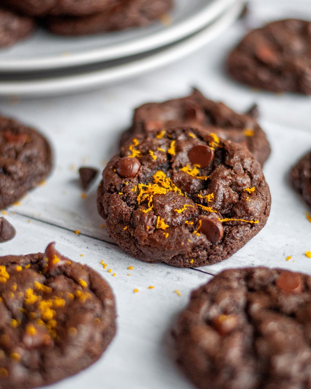 Close-up of fresh orange zest being grated over chocolate cookie dough