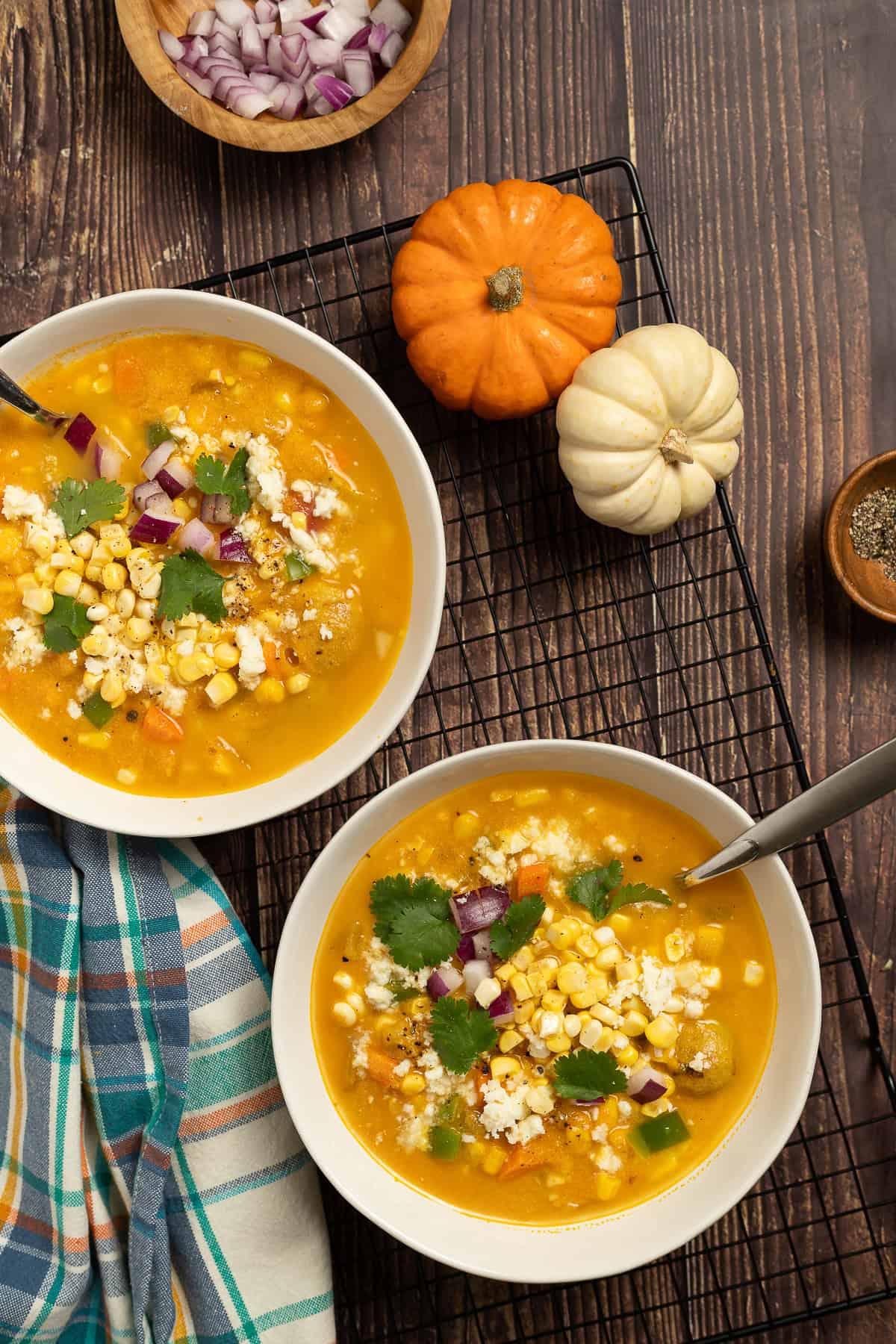 bowl of pumpkin and poblano soup garnished with crema and cilantro