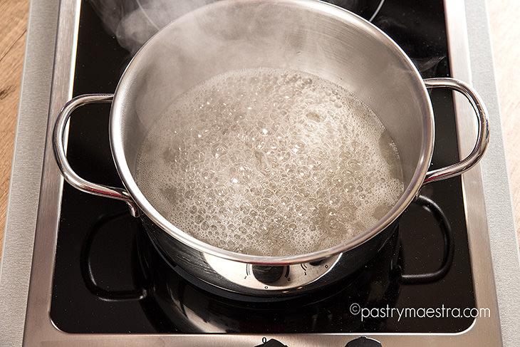 sugar syrup cooking in saucepan