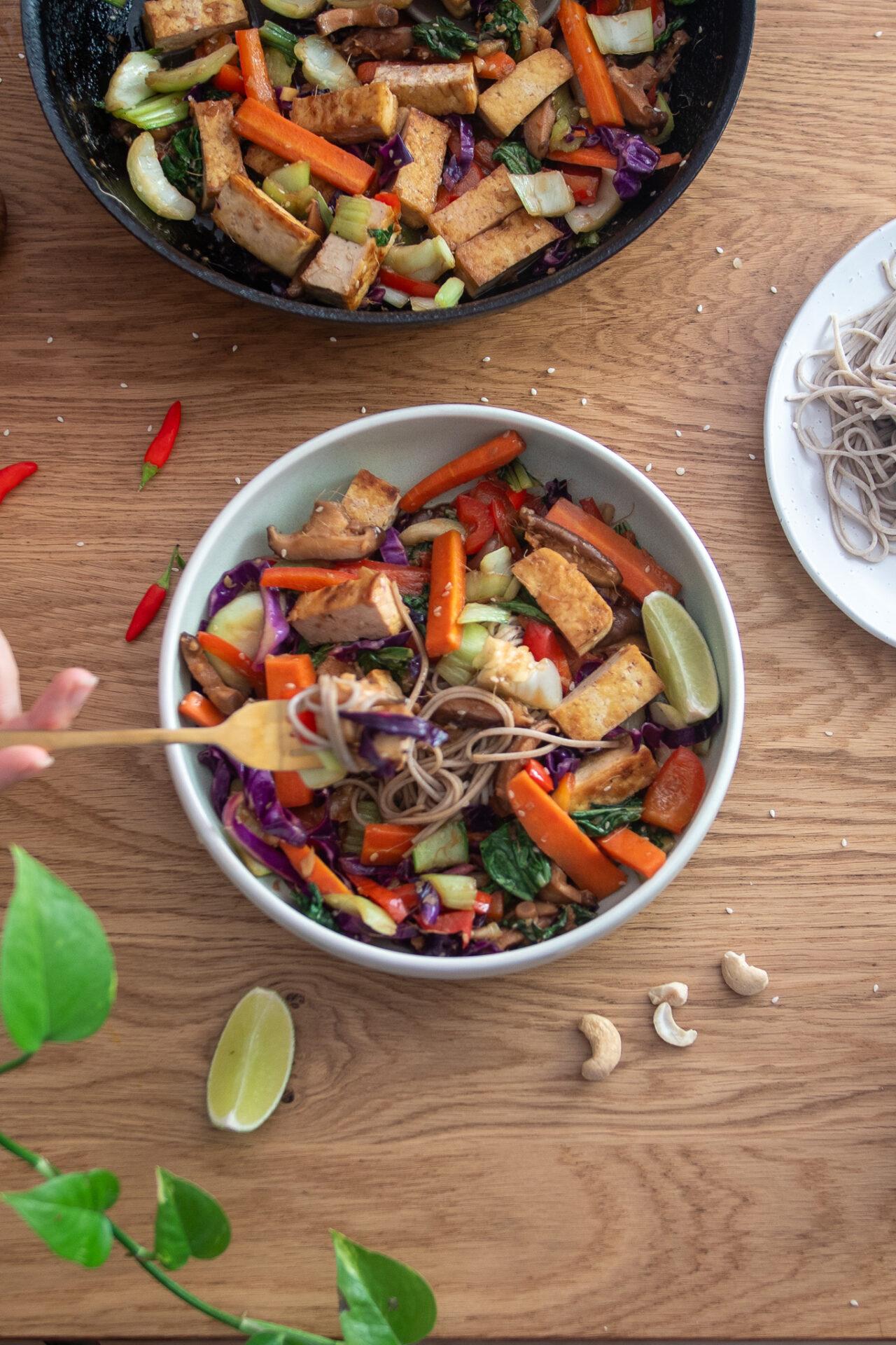 various colorful stir-fry ingredients neatly arranged in bowls, ready for cooking