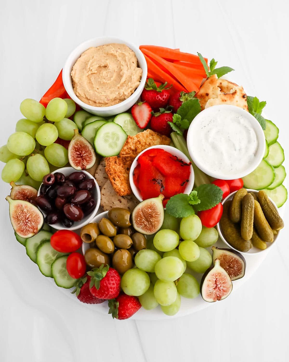 Overhead shot of a beautifully arranged Mediterranean charcuterie board with colorful ingredients