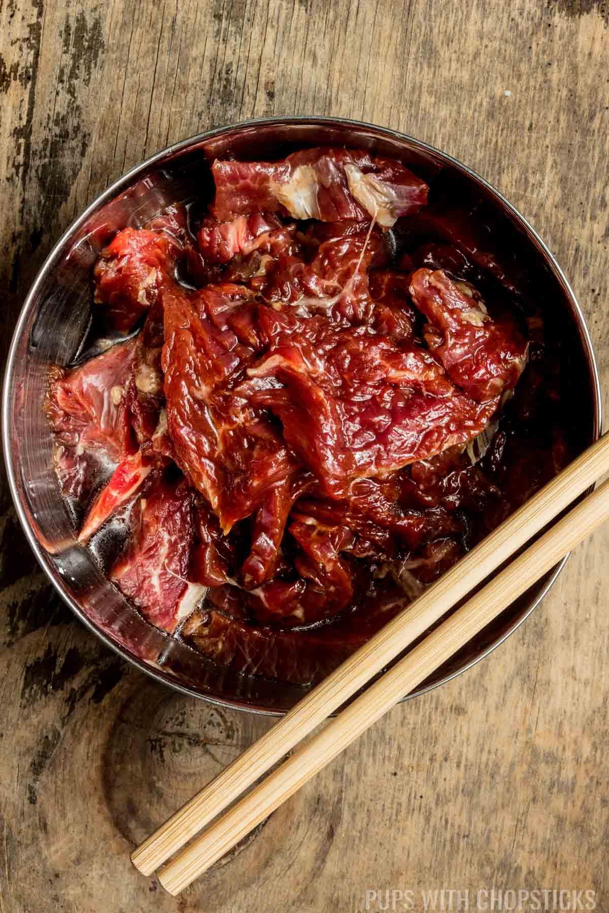 Marinated beef strips in a bowl