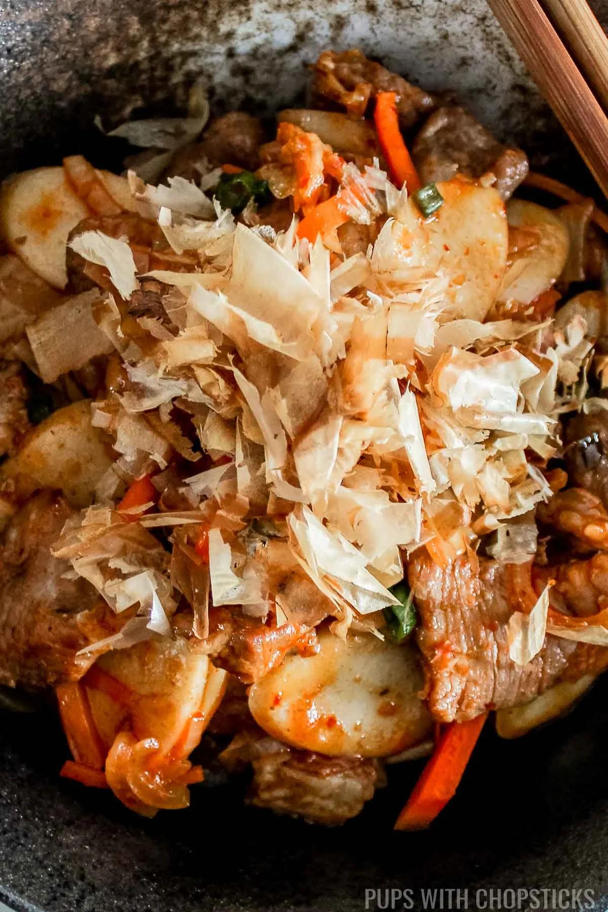Close-up shot of kimchi being stir-fried in a pan