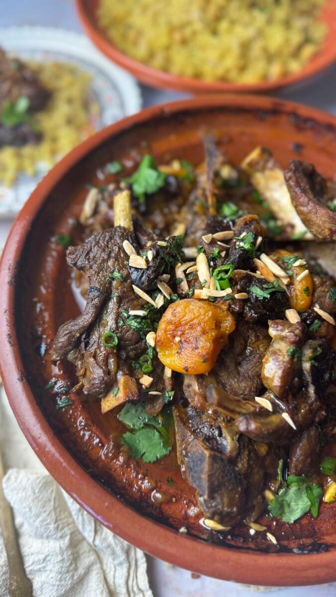 A vibrant Moroccan lamb tagine served in a traditional tagine pot