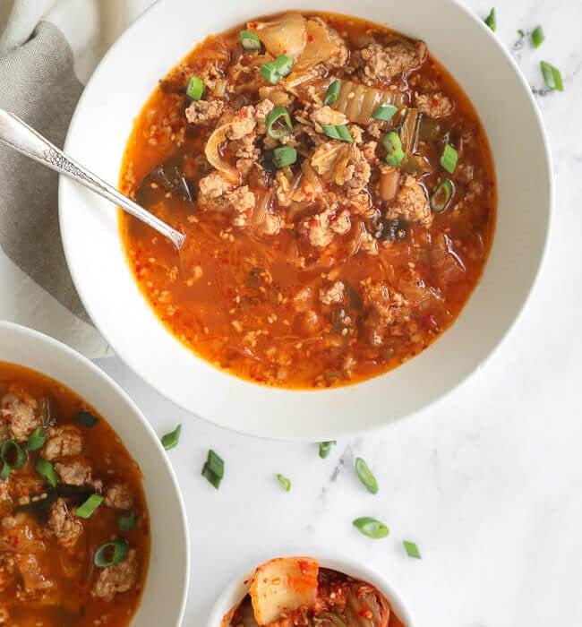 bowl of keto spicy kimchi soup with steam rising