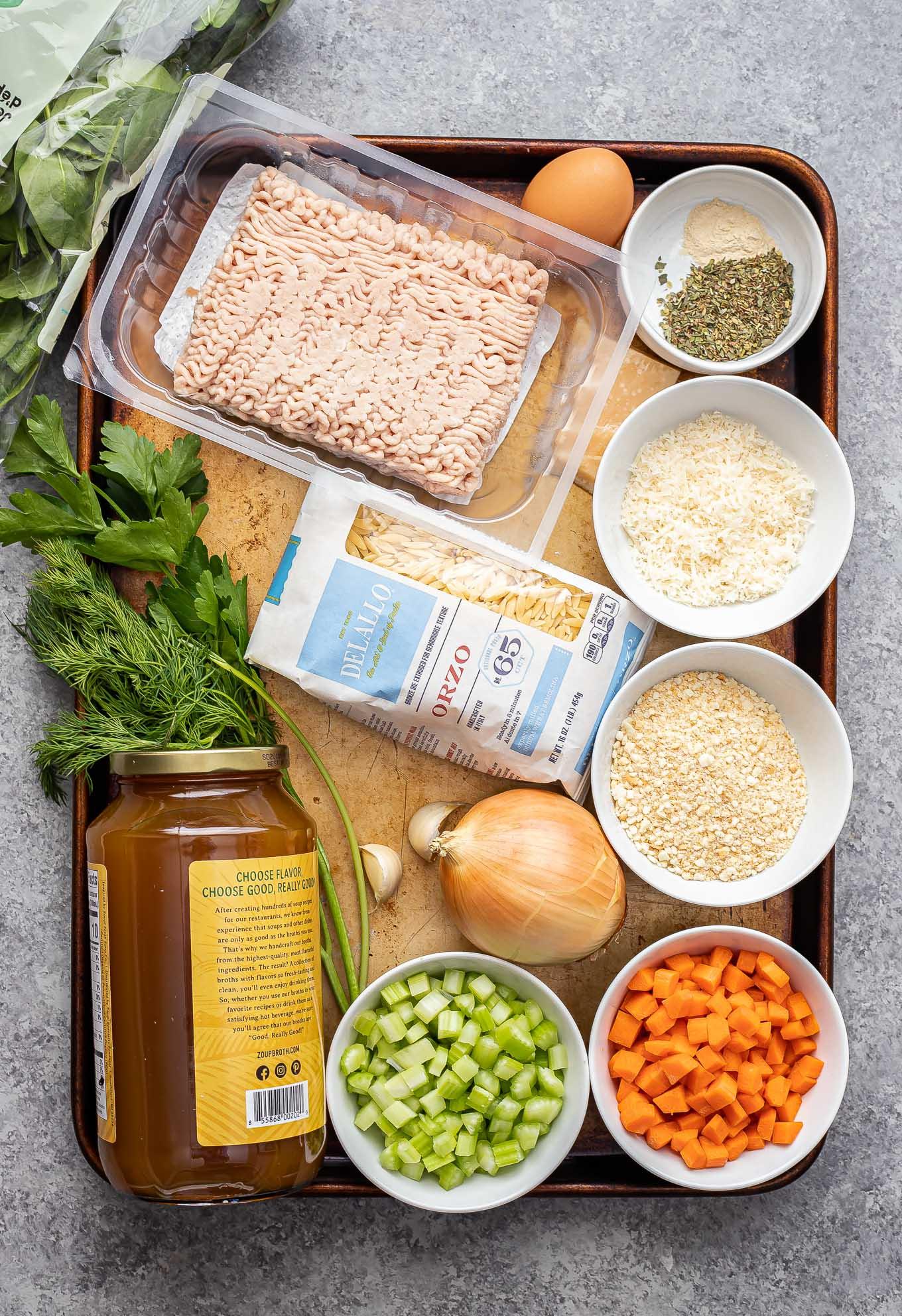 Overhead shot of ingredients for Italian Wedding Stew arranged on a wooden table