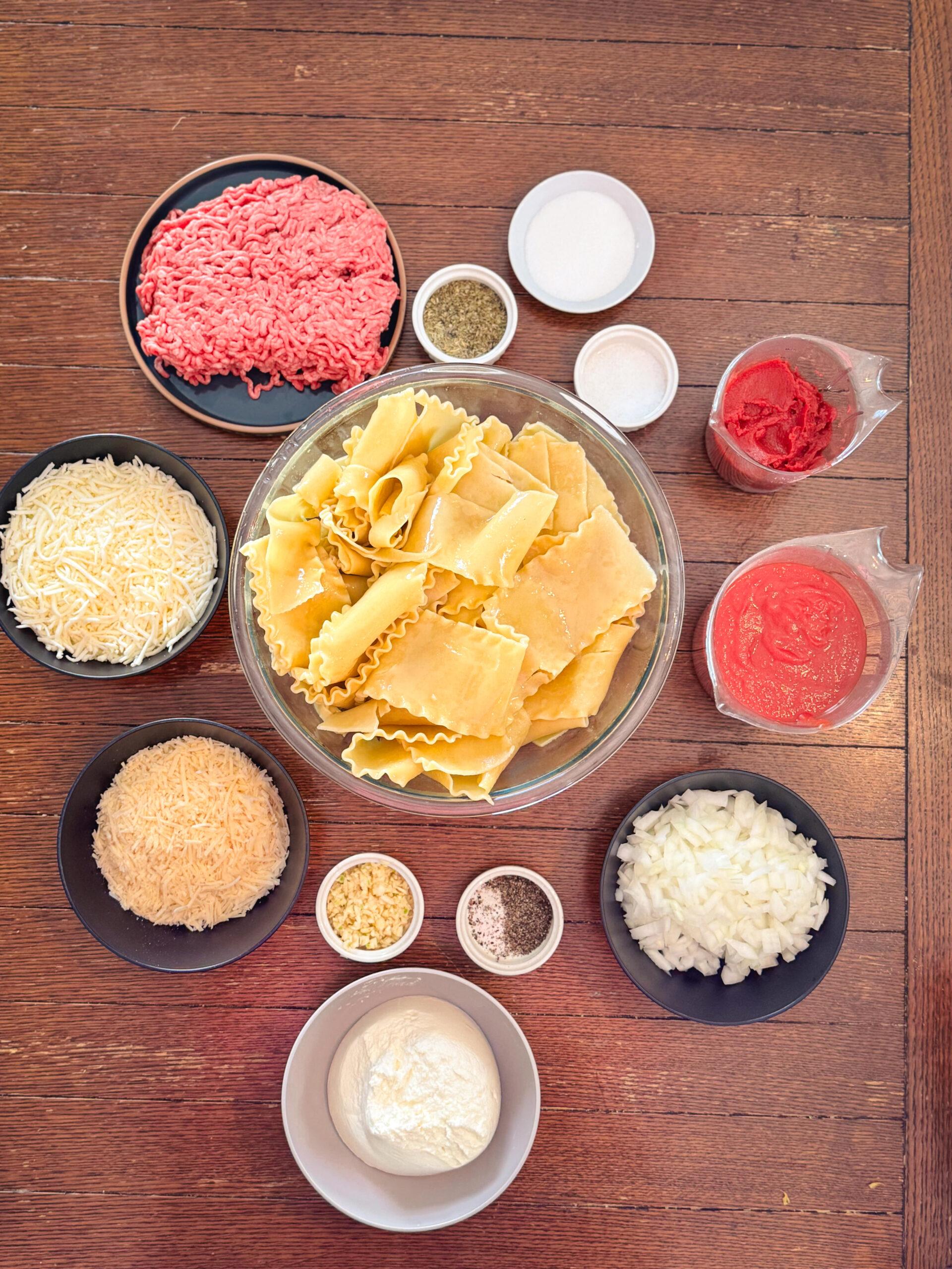 ingredients for camel lasagna laid out on a wooden table