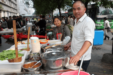 Close-up of a street vendor in Chengdu frying chicken