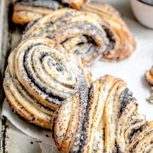 close-up shot of a lemon poppy seed croissant with a visible flaky interior