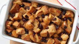 close-up of baked bread pudding with a golden-brown crust and steam rising