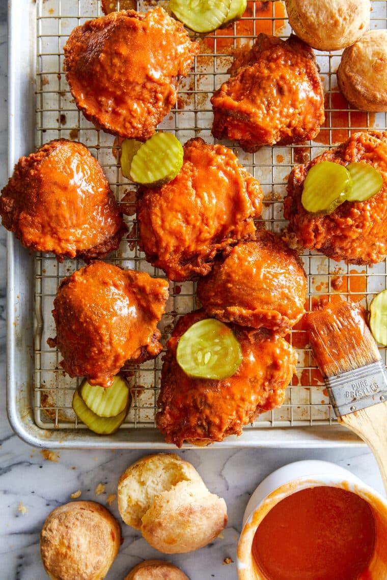 Close-up shot of Nashville hot chicken dumplings with pickles, steam rising