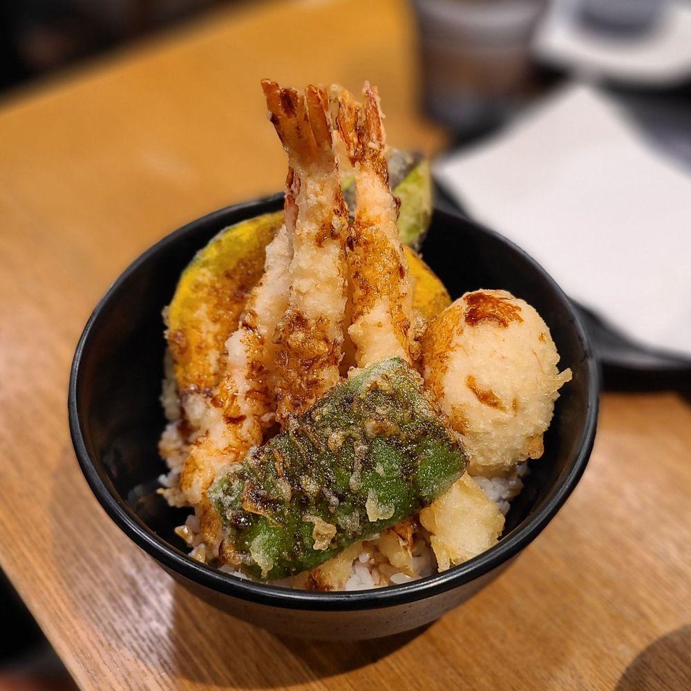 Calamansi tempura drizzled with honey on a plate