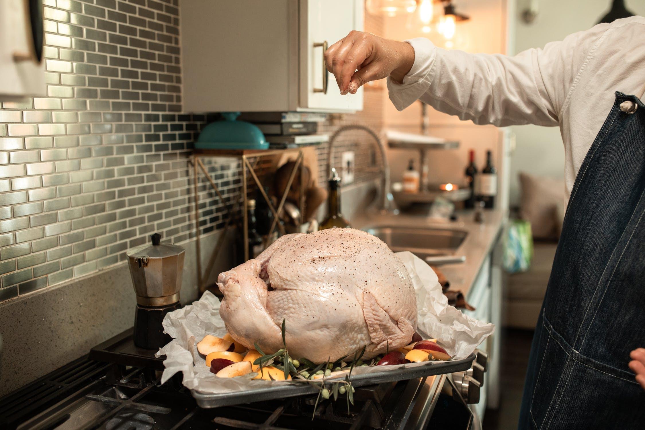 nervous cook looking at a large raw turkey