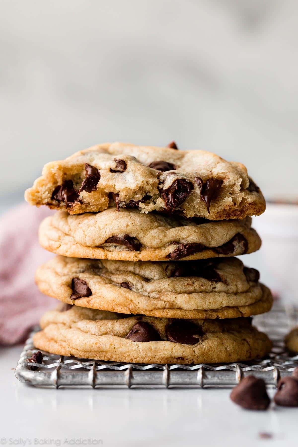 Stack of perfectly baked chocolate chip cookies, showing soft centers and melty chocolate