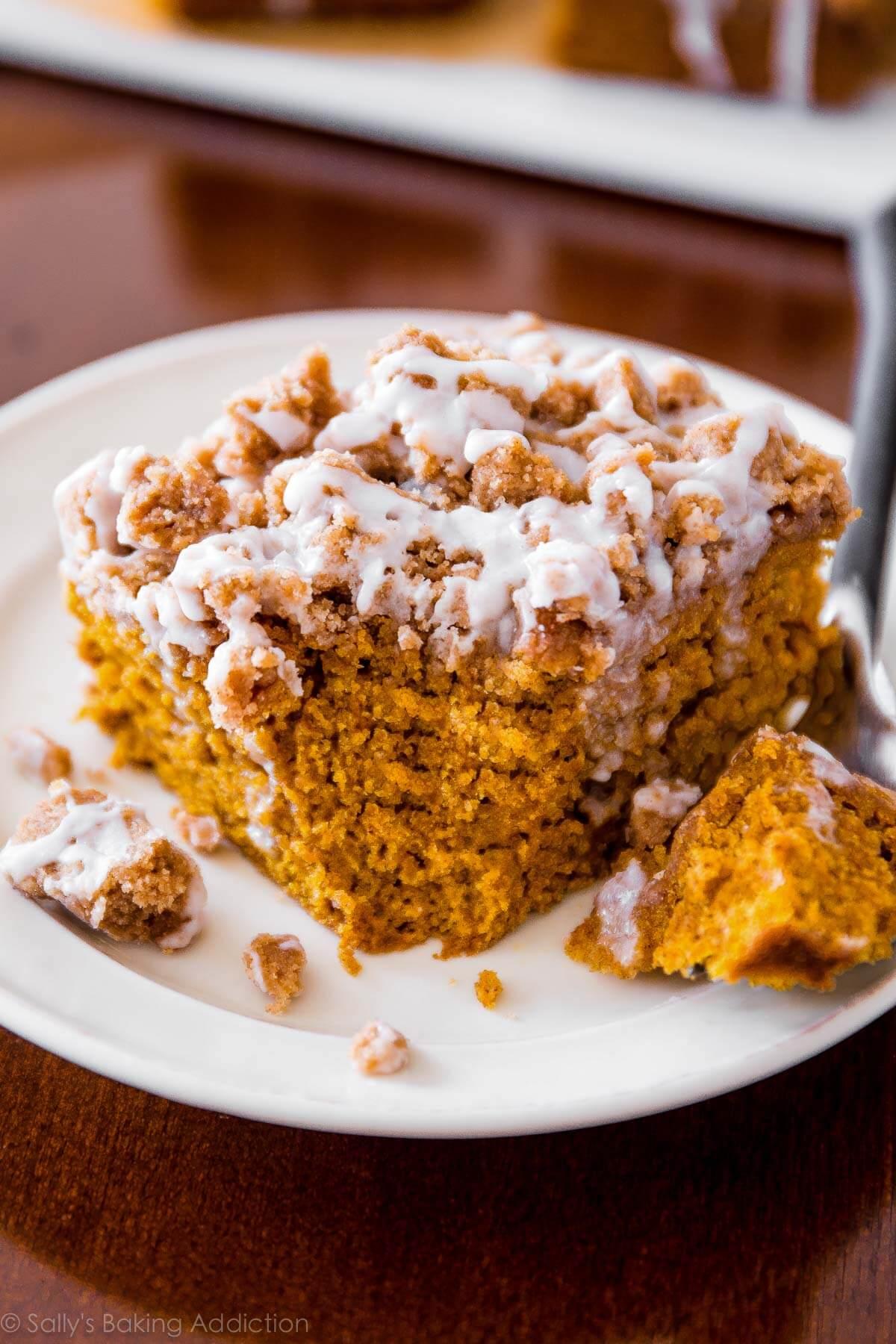 pumpkin coffee cake with a crumb topping, partially sliced