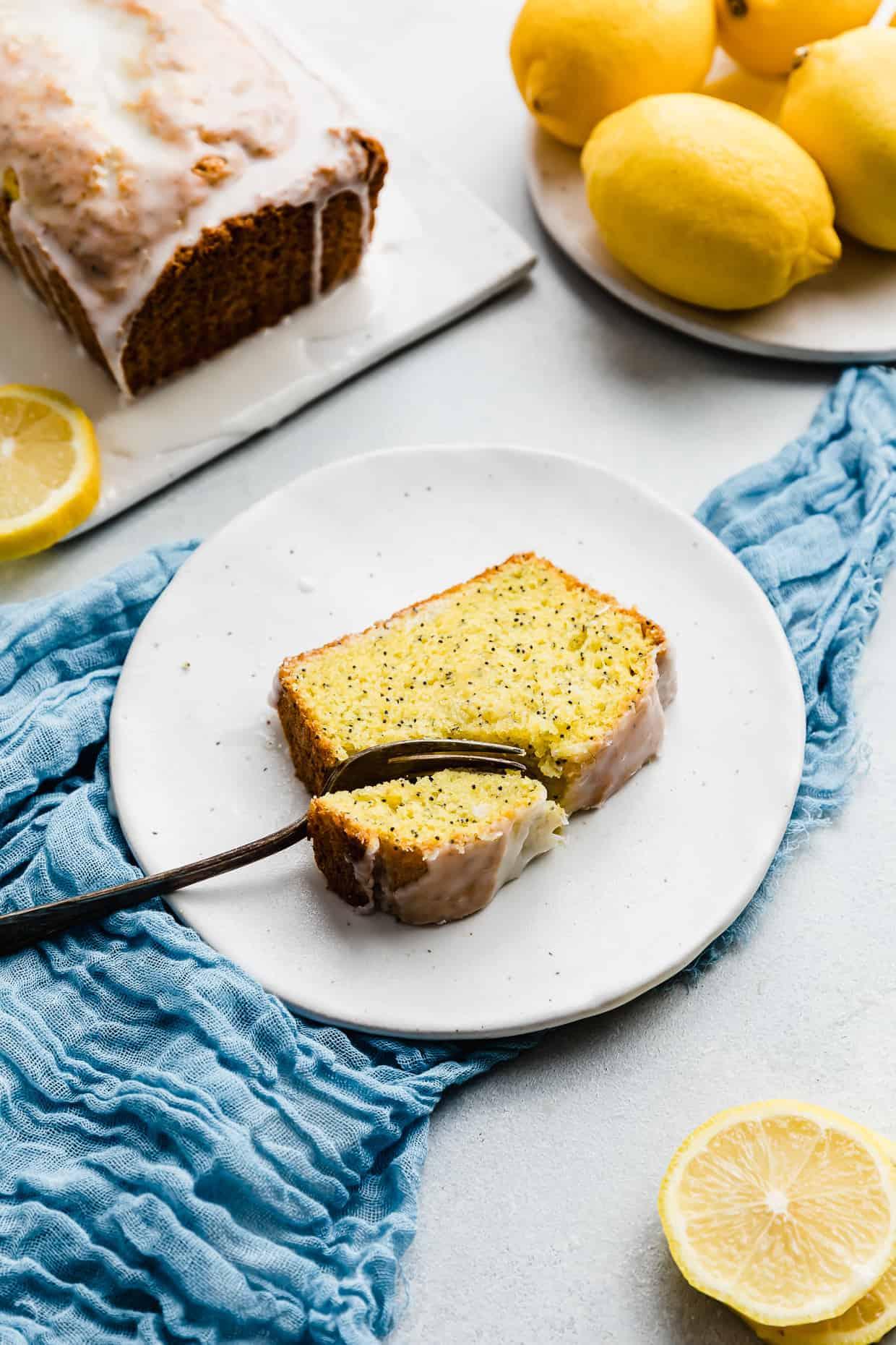 Close up shot of a slice of lemon poppy seed bread pudding served on a plate