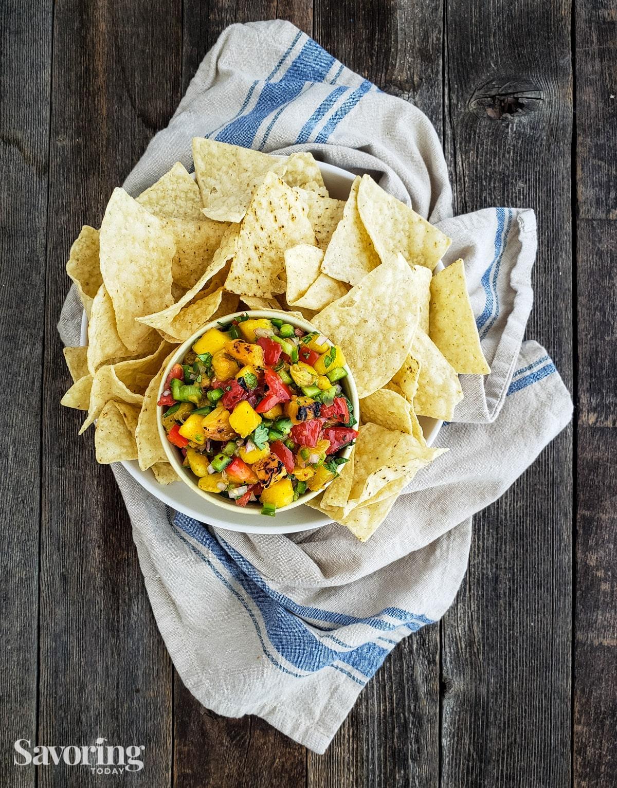 overhead shot of macadamia nut and pineapple salsa with tortilla chips